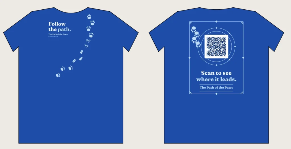Royal blue The Path of the Paws shirt with animal tracks and the slogan Follow the path, front and back with QR code
